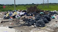 Trash Piles Up on New Vientiane Road Despite Heavy Fines, Warning Sign