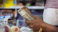 Rupee edges lower as dollar sales by foreign banks offset most of greenback demand