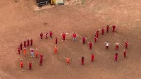 Inmates awaiting deportation make giant ‘SOS’ message with their bodies that can be seen from the skies