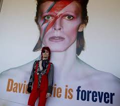 Bowie model and fan, Spencer Wilson, poses for fan photos in front of a Bowie poster at the AGO before the opening of the David Bowie Exhibit at The Art ... - 20130925-ppower070