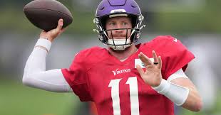 Carson Wentz throws a football and practices archery