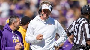 Lane Kiffin gesturing during a press conference at LSU.