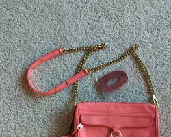 Image of mini leather crossbody bag in a vibrant neon pink color