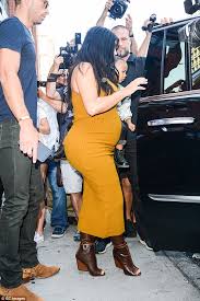 Image result for Her little rock star! Pregnant Kim Kardashian squeezes into another skintight frock as she dresses North in leather trousers and combat boots