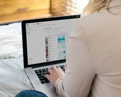 person looking at Instagram analytics on a laptop resmi