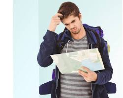 Image of someone holding a map of New York City, looking confused