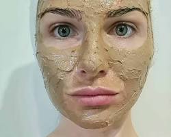 Image of woman applying Cosmelan peel mask