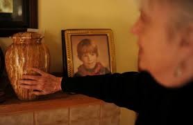 Above, Cynthia Burnett touches an urn she had placed next to a picture of her son Jesse Capen at her house in Denver on Friday. DNA testing may confirm that ... - 20130104__20130105_A14_CD04DUTCHMANJPIC~p1