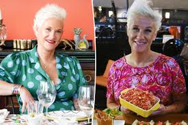 Anne Burrell smiling in a professional kitchen setting