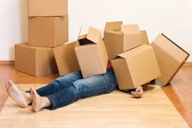 Person under a pile of moving boxes