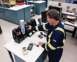Image of Person testing a gas detector with the test button