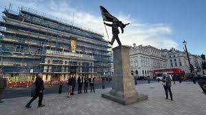 New Banksy Statue in London: A Suited Figure, a Billowing Flag, and the Edge of a Plinth