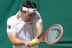 Taylor Fritz of the United States returns the ball to Patrick Kypson of the United States in their second round men\'s singles match at the Wimbledon Tennis Championships in London on Thursday.