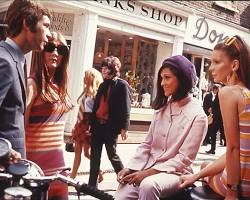 Image of Carnaby Street in 1969, showing a busy street with people dressed in colorful clothing