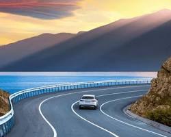 Image of car driving on a scenic road