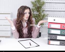 Image of someone looking confused at a stack of documents