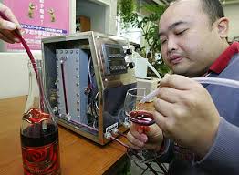 Hiroshi Tanaka, president of Innovative Design and Technology, electrolyzes a bottle of 2005 Beaujolais Nouveau at his laboratory. Photo: AP. Advertisement - 470_winemachine_copy_2,0