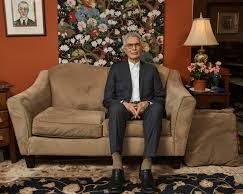 Image of therapist sitting on a couch in a NYC apartment