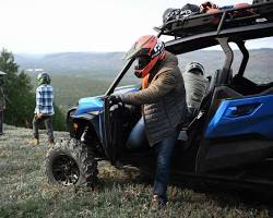 Image of Family riding in a side by side UTV