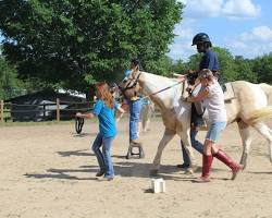 Image of Young person riding a horse