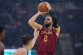 Cleveland Cavaliers guard Max Strus (2) shoots as Dallas Mavericks guard John Poulakidas, left, defends in the first half of an NBA basketball game in Cleveland, Sunday, March 15, 2026.