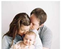Image of happy couple holding a baby
