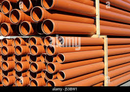 orange sewer pipes at a construction site. Underground ...