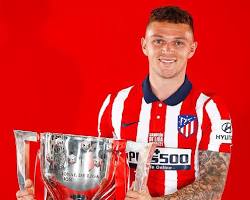 Image of Kieran Trippier holding a trophy