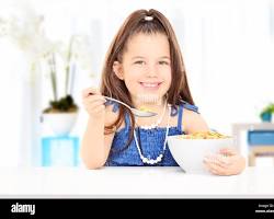 Image of happy oneyearold eating a bowl of cereal