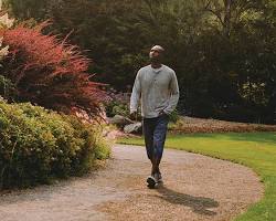 Image of person walking in a park with flowers