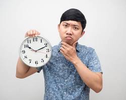 Image of people looking confused at clocks