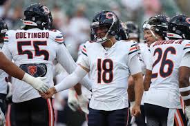 Caleb Williams throwing a football during a Chicago Bears practice session.