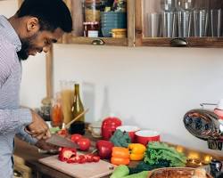 person cooking delicious food in their home kitchen resmi