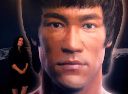 Shannon Lee, daughter of the late Kung Fu legend Bruce Lee, poses beside a portrait of her father at the Hong Kong Heritage Museum, before the start of a ... - REU-HONGKONG-BRUCELEE-DEATH