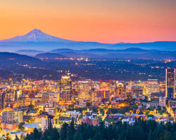 Image of Portland, Oregon's cityscape with a food cart pod and Mt. Hood in the distance