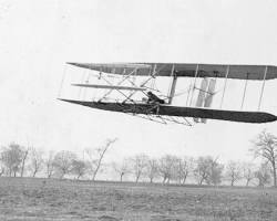 Image of Wright brothers and their airplane