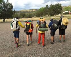 Gambar Backpacker trying on different backpacks