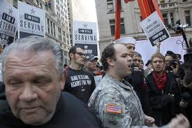 Jerry Bordeleau, 24, center, from New York, an Army veteran who served in Iraq, speaks to protesters and supporters of the Occupy Wall Street movement at ... - ows_veterans2_ap_img