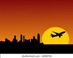 Image of plane flying over Atlanta skyline