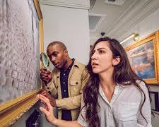 Image of couple in an escape room looking for clues