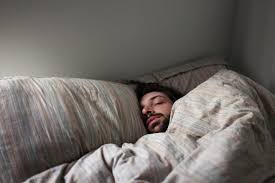 Image result for picture of a man sleeping on a bed