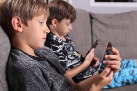 Child using a tablet, with a stylized heart overlay.