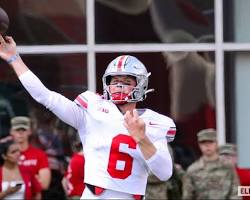 Image of Kyle McCord in Ohio State uniform throwing a football