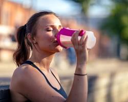 person drinking a protein shake on a tripの画像
