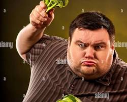 person eating a healthy meal with vegetablesの画像