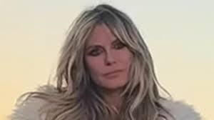 Heidi Klum, 52, goes TOPLESS under fuzzy coat as she teases new song with Diplo in racy clip