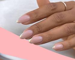 Image of hand with a classic french manicure with a gold glitter tip