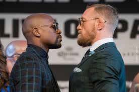 A split image showing Floyd Mayweather and Conor McGregor in their fighting stances.