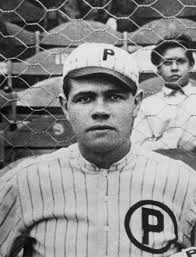 Babe Ruth, pitcher for the Providence Grays minor league team, poses for a team - 960x540