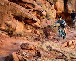 Image of mountain biker conquering a rocky climb